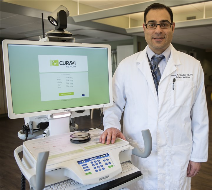 The Curavi cart. Dr. Steven Handler poses Thursday next to the Curavi Cart at the Charles Morris Nursing and Rehabilitation Center in Squirrel Hill, Pennsylvania